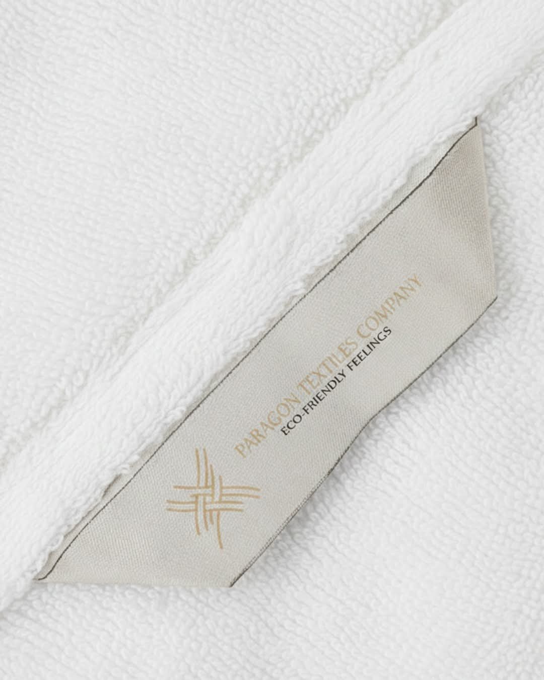 Close-up of a Paragon Textile woven satin label stitched to a white cotton towel