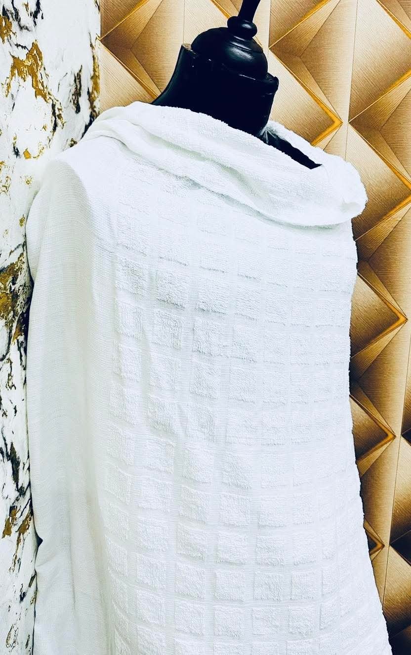 Two-piece white cotton Ihram cloth for Hajj and Umrah draped on a form